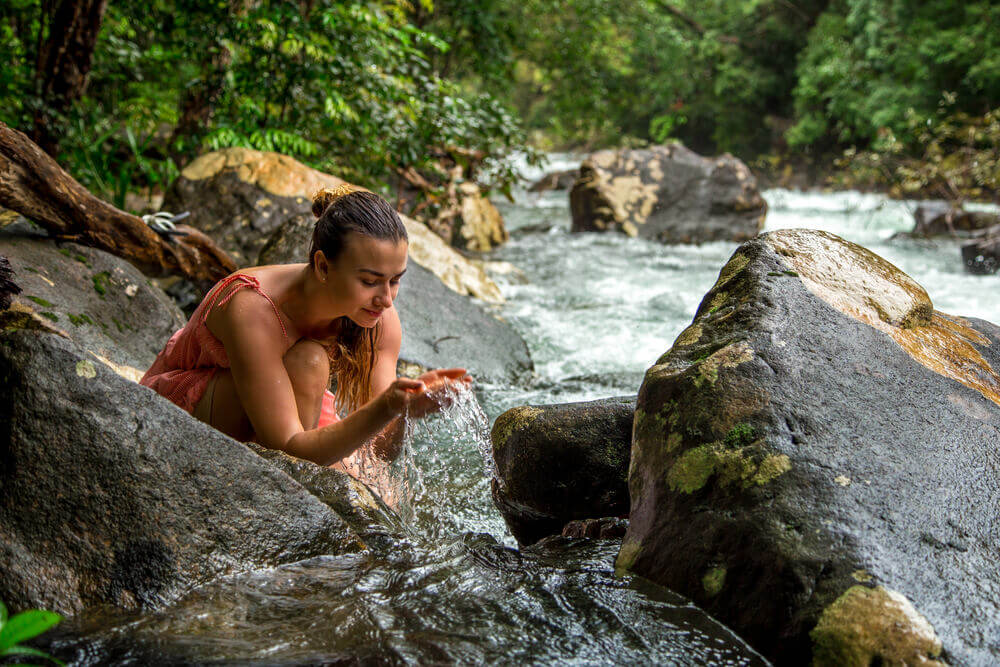 Person enjoying nature and wellness tour by a river
