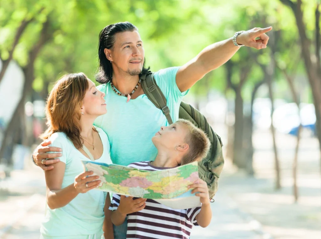 A family examines a map outdoors, representing family-friendly local tour ideas.